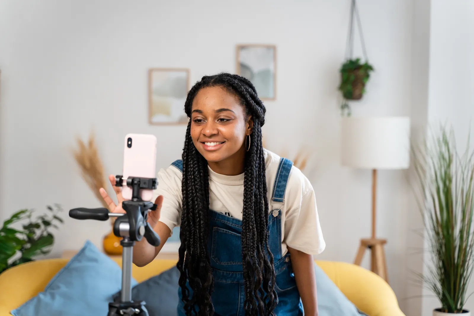 Creator filming a video with her phone on a tripod