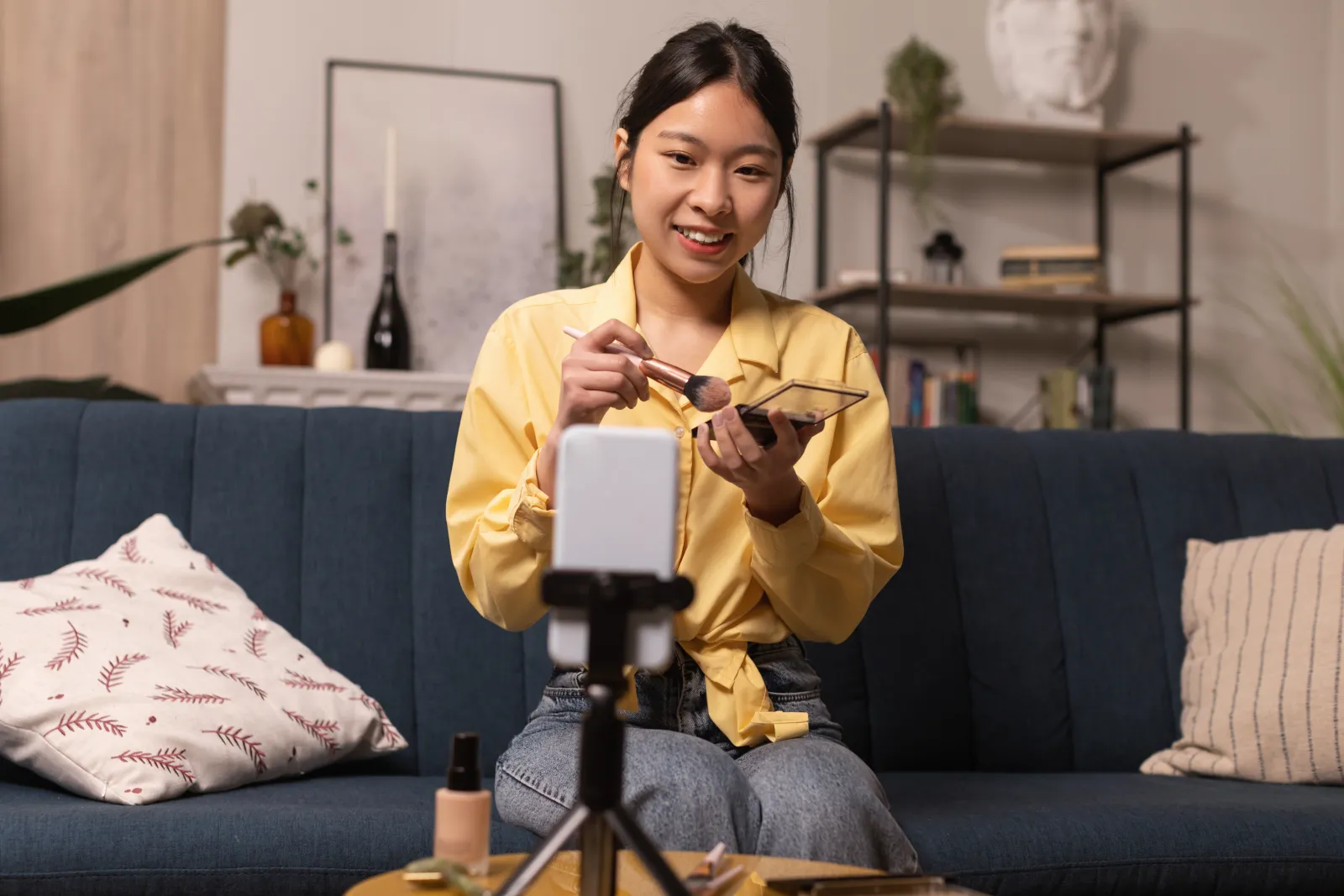Creator filming a smartphone video in her home studio